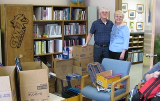 The Austins with boxes of donated school supplies